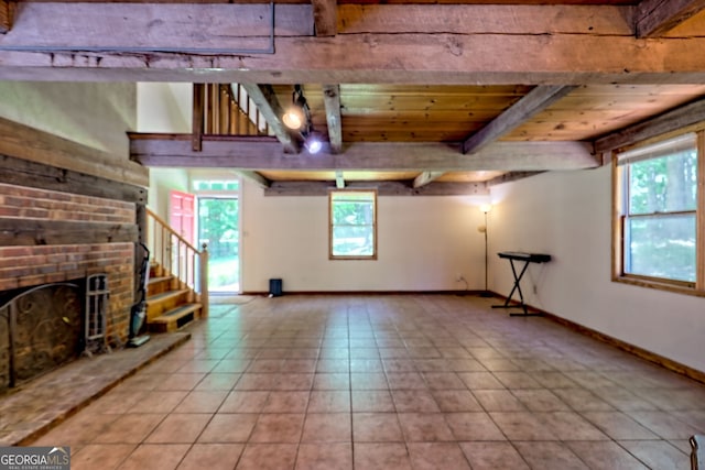 218 Jefferson Pl, Toccoa, GA 30577 - unfurnished living room featuring a brick fireplace, stairs, wooden ceiling with exposed beams, baseboards, and tile patterned flooring