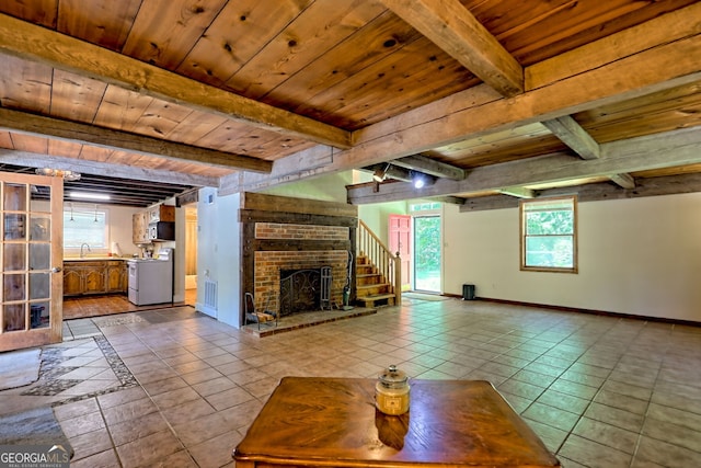 218 Jefferson Pl, Toccoa, GA 30577 - unfurnished living room featuring wooden ceiling with exposed beams, baseboards, dark tile patterned flooring, a sink, and a fireplace