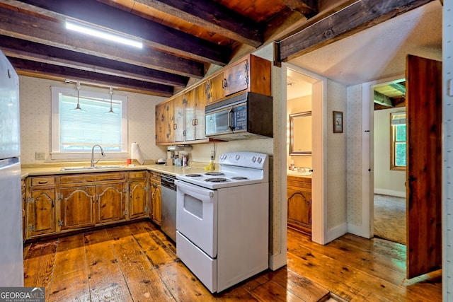 218 Jefferson Pl, Toccoa, GA 30577 - kitchen featuring stainless steel appliances, a sink, hardwood / wood-style flooring, brown cabinetry, and beam ceiling