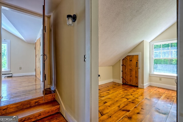 218 Jefferson Pl, Toccoa, GA 30577 - bonus room with lofted ceiling, hardwood / wood-style floors, baseboard heating, a textured ceiling, and baseboards