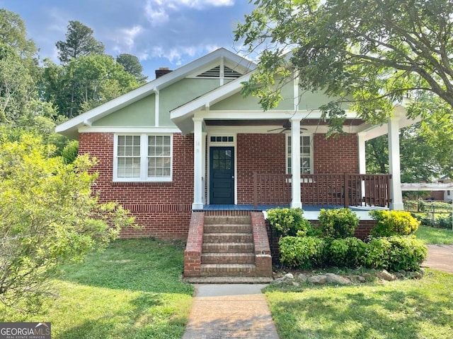 14 J Ave, Gainesville, GA 30504 - bungalow-style home featuring a porch, ceiling fan, brick siding, a front yard, and a chimney