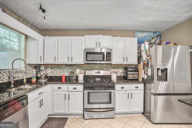 6076 Chupp Way Ln, Lithonia, GA 30038 - kitchen with stainless steel appliances, a sink, white cabinetry, decorative backsplash, and light tile patterned floors