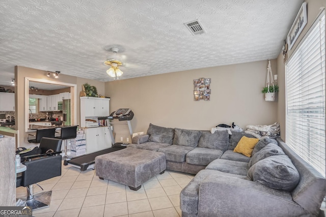 6076 Chupp Way Ln, Lithonia, GA 30038 - living room with light tile patterned floors and a textured ceiling
