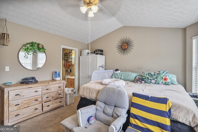 6076 Chupp Way Ln, Lithonia, GA 30038 - bedroom featuring carpet flooring, a textured ceiling, lofted ceiling, ensuite bathroom, and a ceiling fan