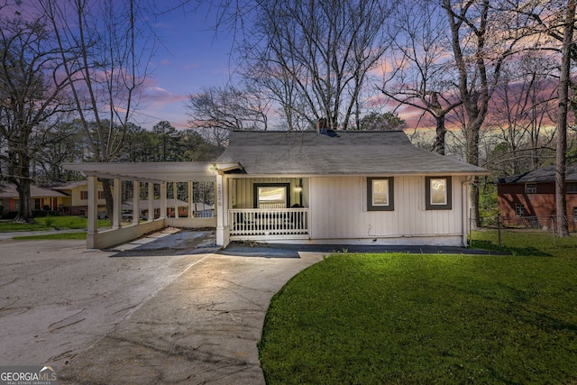 2826 Ben Hill Rd, East Point, GA 30344 - view of front facade featuring a porch, asphalt driveway, a chimney, a carport, and a shingled roof