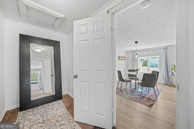 2826 Ben Hill Rd, East Point, GA 30344 - corridor with a textured ceiling, plenty of natural light, attic access, baseboards, and wood finished floors