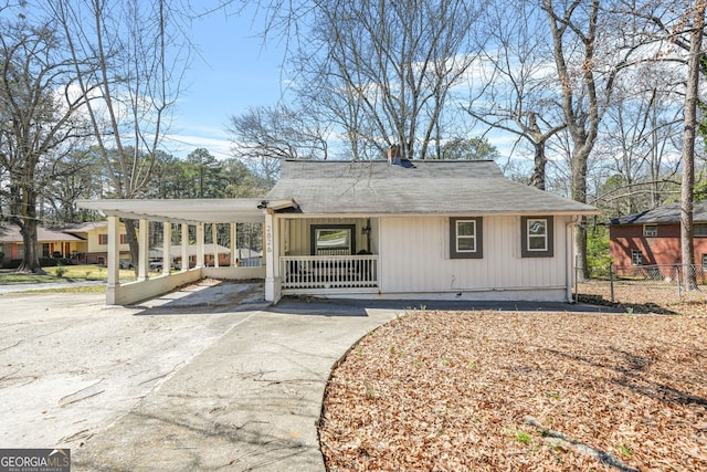 2826 Ben Hill Rd, East Point, GA 30344 - view of front of home with a porch, driveway, a chimney, and a shingled roof