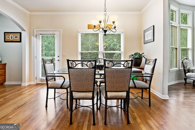1898 Alcovy Shoals Blf SE, Lawrenceville, GA 30045 - dining space with arched walkways, wood finished floors, a chandelier, baseboards, and ornamental molding