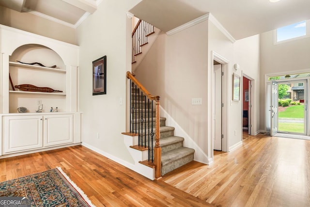 1898 Alcovy Shoals Blf SE, Lawrenceville, GA 30045 - stairs featuring wood finished floors, a high ceiling, ornamental molding, baseboards, and built in shelves
