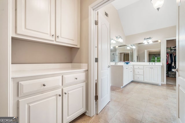 1898 Alcovy Shoals Blf SE, Lawrenceville, GA 30045 - full bathroom featuring vanity, lofted ceiling, tile patterned flooring, and a spacious closet
