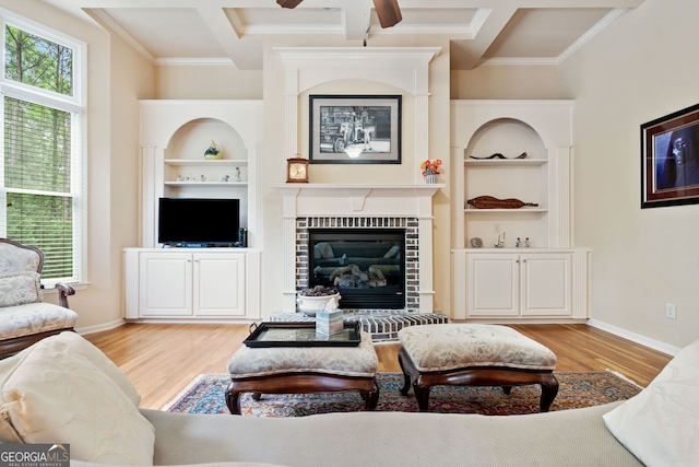 1898 Alcovy Shoals Blf SE, Lawrenceville, GA 30045 - living area with light wood-style flooring, crown molding, a brick fireplace, baseboards, and ceiling fan