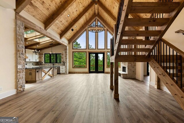 458 Palisade Dr Unit 2142, Ellijay, GA 30540 - unfurnished living room with a chandelier, high vaulted ceiling, hardwood / wood-style flooring, baseboards, and wood ceiling with exposed beams
