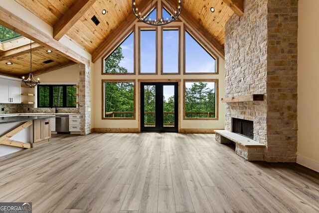 458 Palisade Dr Unit 2142, Ellijay, GA 30540 - unfurnished living room with a chandelier, high vaulted ceiling, wood ceiling with exposed beams, baseboards, and light wood-style flooring