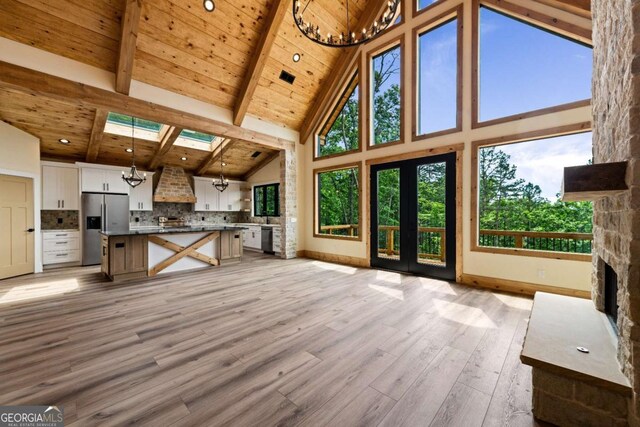 458 Palisade Dr Unit 2142, Ellijay, GA 30540 - unfurnished living room featuring a chandelier, high vaulted ceiling, wooden ceiling with exposed beams, light wood-style flooring, and baseboards