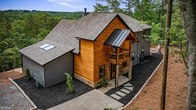 458 Palisade Dr Unit 2142, Ellijay, GA 30540 - view of front facade featuring a chimney, roof with shingles, central AC, a forest view, and a balcony