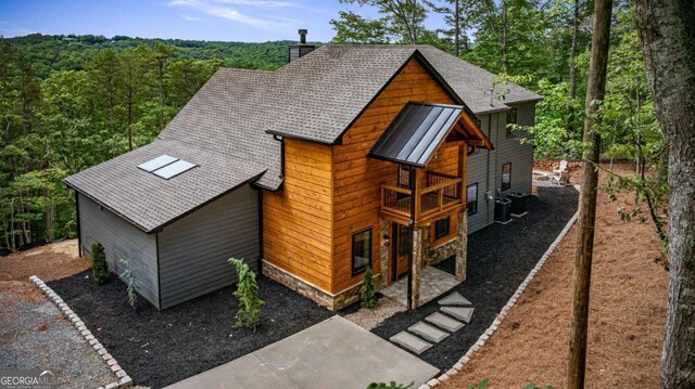 458 Palisade Dr Unit 2142, Ellijay, GA 30540 - view of front facade featuring a chimney, roof with shingles, central AC, a forest view, and a balcony