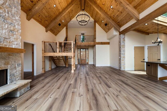 458 Palisade Dr Unit 2142, Ellijay, GA 30540 - unfurnished living room featuring a chandelier, wood finished floors, a high ceiling, wooden ceiling with exposed beams, and baseboards