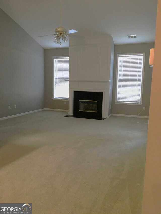 175 Camry Ln, Grayson, GA 30017 - unfurnished living room featuring ceiling fan, vaulted ceiling, carpet, baseboards, and a glass covered fireplace