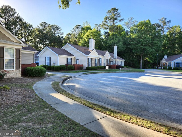 175 Camry Ln, Grayson, GA 30017 - view of home's exterior with a chimney and a shingled roof