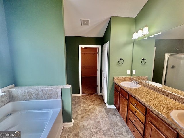 9108 Alden Dr, Locust Grove, GA 30248 - full bathroom featuring a stall shower, a garden tub, double vanity, and a walk in closet