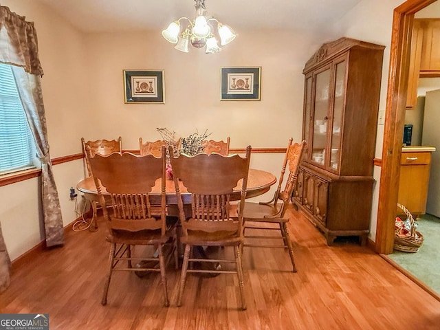 147 Glen Oaks Rd, Perry, GA 31069 - dining space featuring light wood finished floors and a chandelier