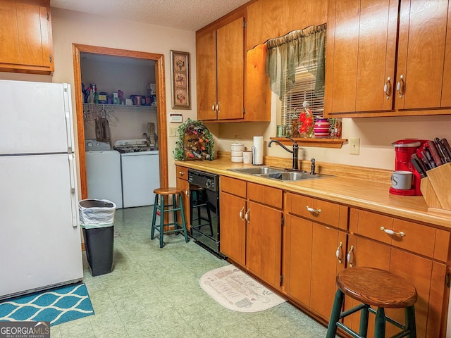 147 Glen Oaks Rd, Perry, GA 31069 - kitchen with freestanding refrigerator, washer and clothes dryer, dishwasher, a sink, and light countertops