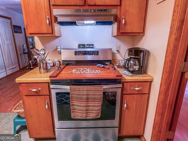 147 Glen Oaks Rd, Perry, GA 31069 - kitchen featuring under cabinet range hood, stainless steel range, light countertops, and brown cabinets