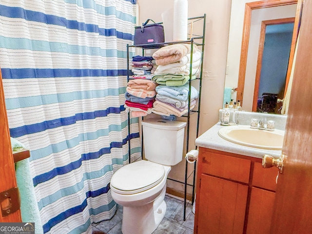 147 Glen Oaks Rd, Perry, GA 31069 - bathroom with toilet, vanity, tile patterned floors, and a shower with shower curtain