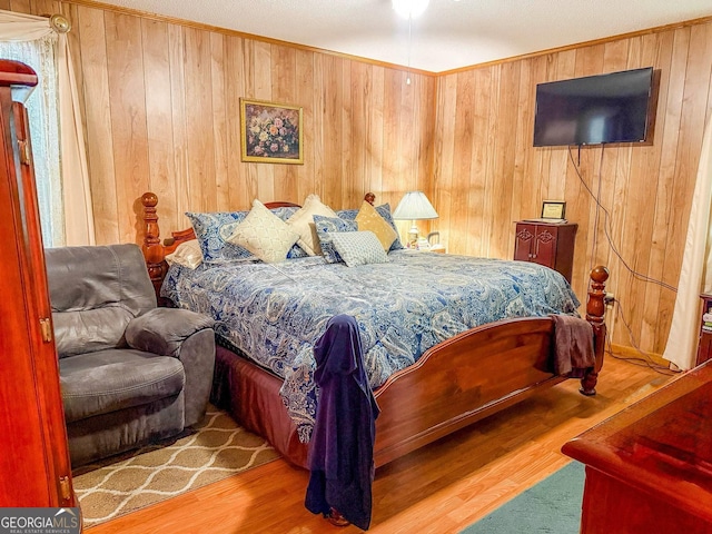 147 Glen Oaks Rd, Perry, GA 31069 - bedroom with wood finished floors, crown molding, and wood walls