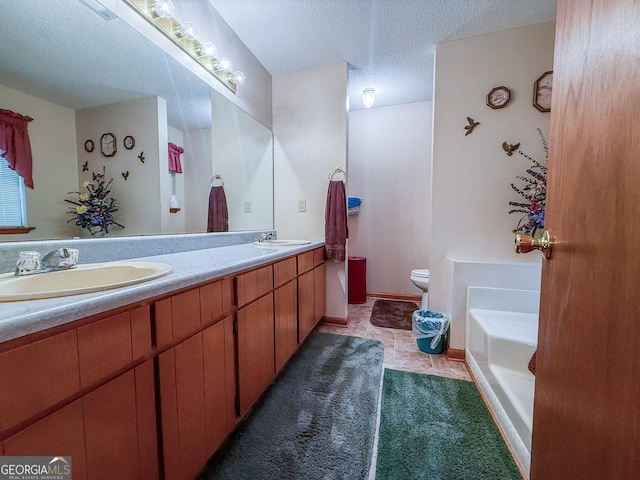 147 Glen Oaks Rd, Perry, GA 31069 - bathroom with double vanity, a garden tub, toilet, a textured ceiling, and tile patterned flooring