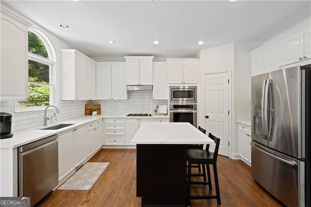 4108 Wyndam Hill Dr, Suwanee, GA 30024 - kitchen featuring stainless steel appliances, white cabinetry, a center island, backsplash, and recessed lighting