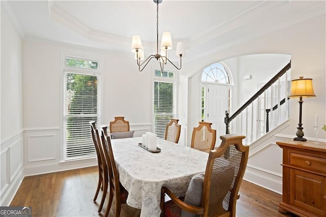 4108 Wyndam Hill Dr, Suwanee, GA 30024 - dining space featuring healthy amount of natural light, a chandelier, a decorative wall, ornamental molding, and dark wood finished floors