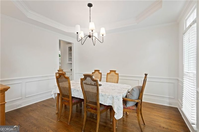 4108 Wyndam Hill Dr, Suwanee, GA 30024 - dining area with a chandelier, a tray ceiling, dark wood finished floors, ornamental molding, and a wainscoted wall