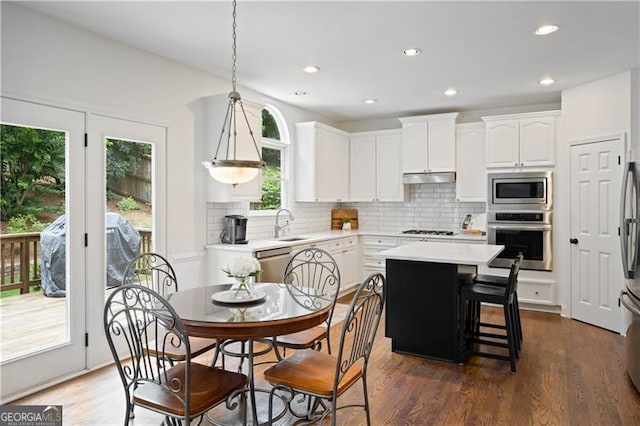 4108 Wyndam Hill Dr, Suwanee, GA 30024 - kitchen featuring stainless steel appliances, white cabinetry, backsplash, light countertops, and recessed lighting