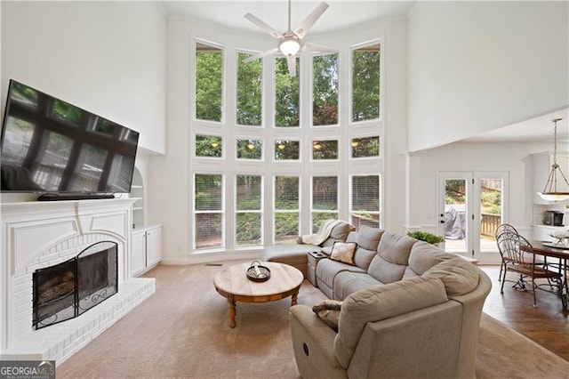 4108 Wyndam Hill Dr, Suwanee, GA 30024 - living area with a towering ceiling, a ceiling fan, and a brick fireplace