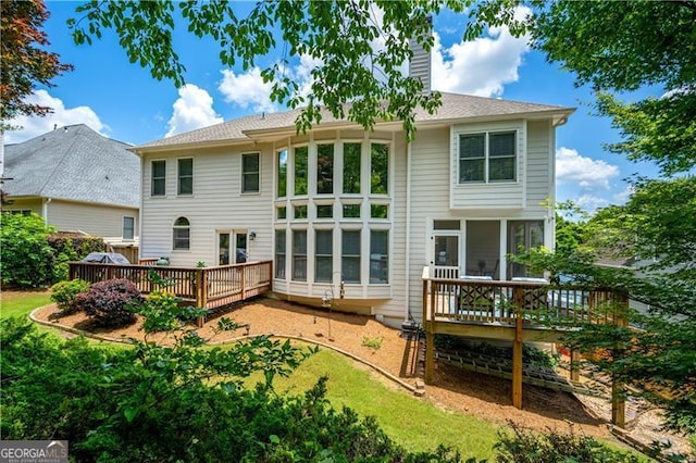 4108 Wyndam Hill Dr, Suwanee, GA 30024 - back of house featuring a deck, a chimney, and a sunroom