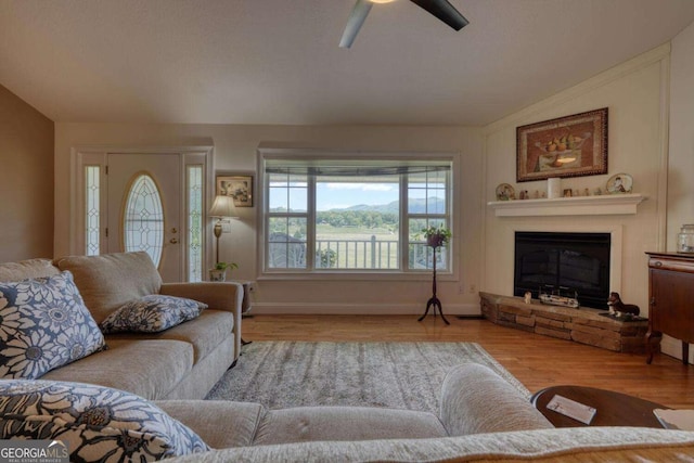 2008 Hidden Valley Rd, Hiawassee, GA 30546 - living area featuring ceiling fan, wood finished floors, a glass covered fireplace, and baseboards