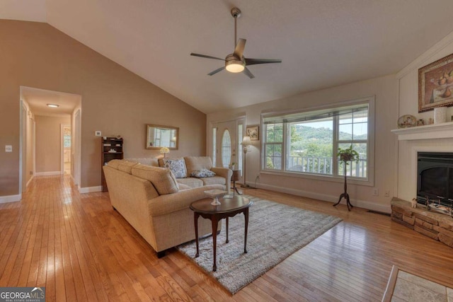 2008 Hidden Valley Rd, Hiawassee, GA 30546 - living area with light wood-type flooring, ceiling fan, lofted ceiling, and a glass covered fireplace