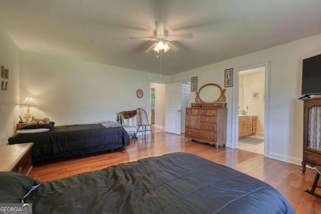 2008 Hidden Valley Rd, Hiawassee, GA 30546 - bedroom with wood finished floors, connected bathroom, and a ceiling fan