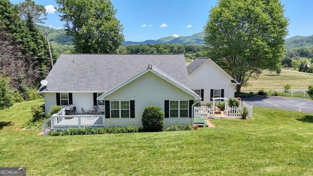 2008 Hidden Valley Rd, Hiawassee, GA 30546 - back of property with a lawn, a deck with mountain view, and a shingled roof