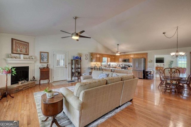 2008 Hidden Valley Rd, Hiawassee, GA 30546 - living room with ceiling fan, healthy amount of natural light, light wood-style flooring, a chandelier, and high vaulted ceiling