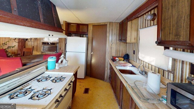 85 Lang Cir, Covington, GA 30014 - kitchen featuring white appliances, light countertops, and brown cabinets