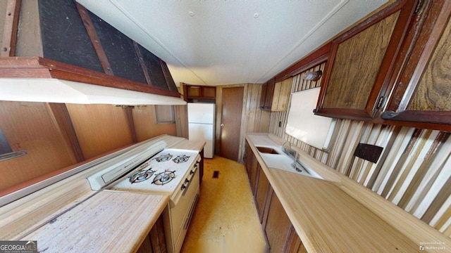 85 Lang Cir, Covington, GA 30014 - kitchen with freestanding refrigerator, light countertops, and brown cabinetry