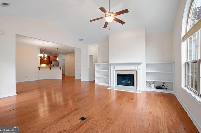 2061 Grove Field Ln, Marietta, GA 30064 - unfurnished living room with ceiling fan, light wood-type flooring, lofted ceiling, a chandelier, and baseboards