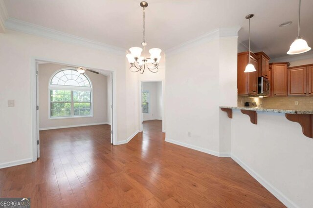 2061 Grove Field Ln, Marietta, GA 30064 - unfurnished living room with a chandelier, crown molding, light wood-style floors, baseboards, and recessed lighting