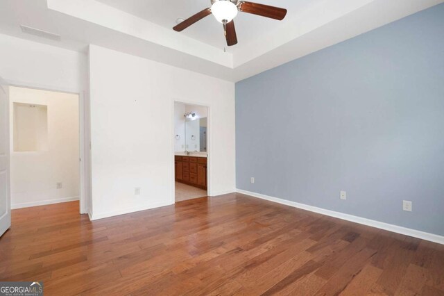 2061 Grove Field Ln, Marietta, GA 30064 - unfurnished room with a tray ceiling, wood finished floors, ceiling fan, and baseboards