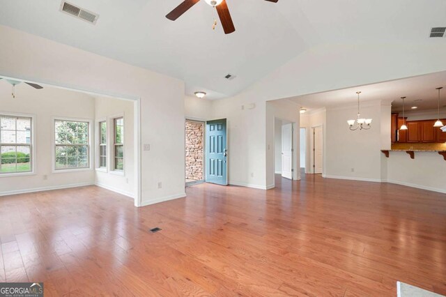 2061 Grove Field Ln, Marietta, GA 30064 - unfurnished living room with a ceiling fan, a fireplace with raised hearth, wood finished floors, lofted ceiling, and baseboards
