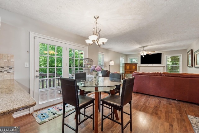 1679 Summit Place Way, Loganville, GA 30052 - dining area featuring a textured ceiling, wood finished floors, healthy amount of natural light, a ceiling fan, and a chandelier