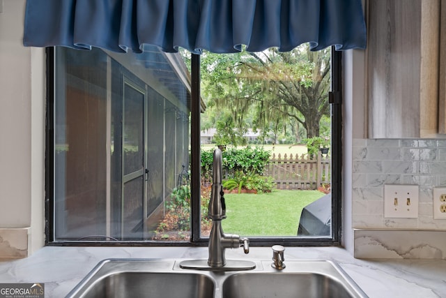 107 Linkside Dr, Saint Simons, GA 31522 - detailed view of a sink, backsplash, and light stone countertops