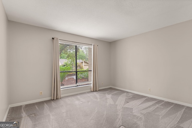107 Linkside Dr, Saint Simons, GA 31522 - unfurnished room with light carpet, baseboards, and a textured ceiling